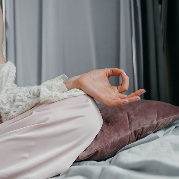Close-up of a person's hands in a meditative pose, focus on calmness.